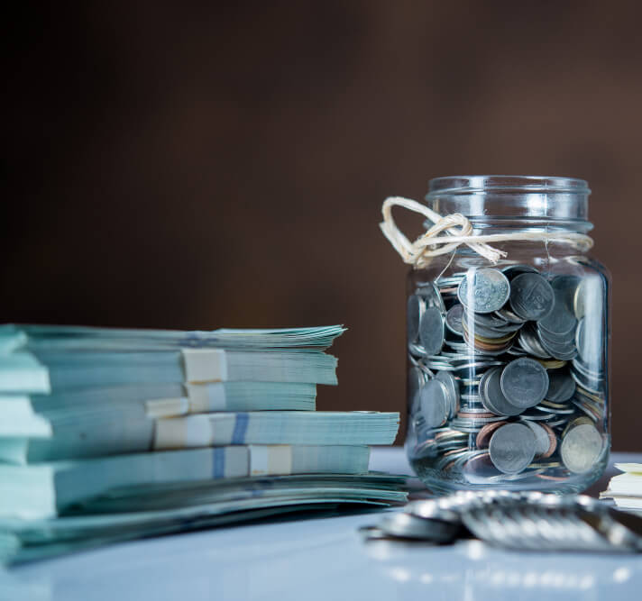 bottles-cash-with-coins-saving-money-concept (1)