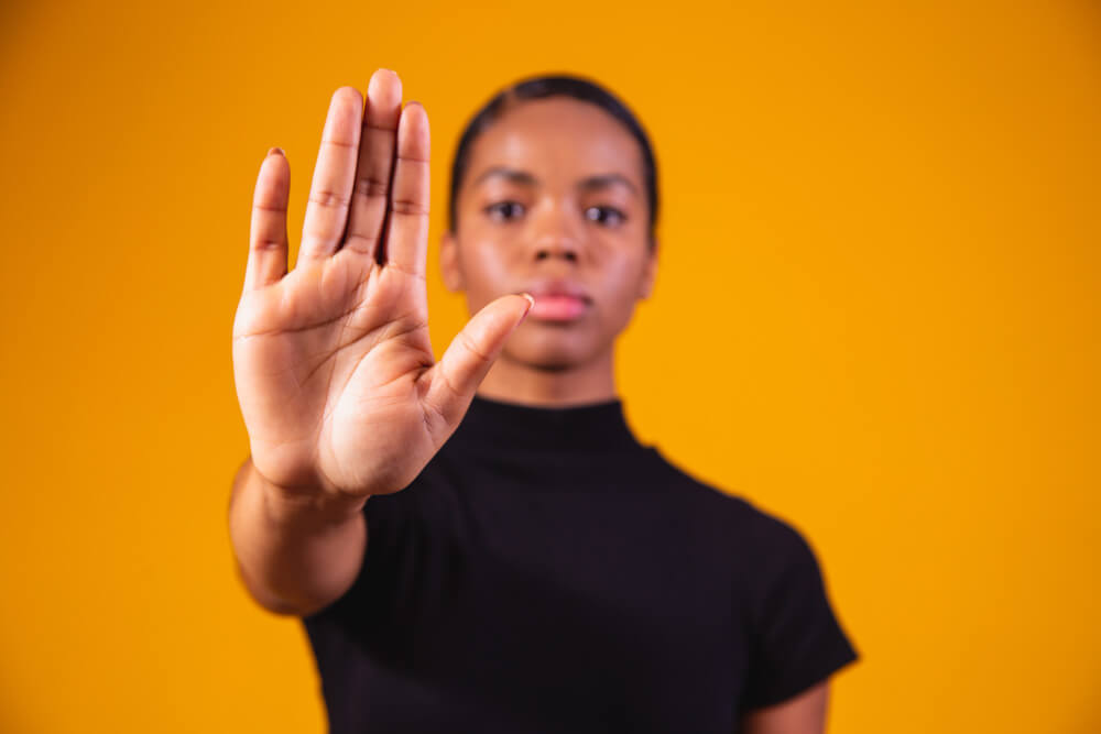 young-african-american-woman-shown-hand-sign-them-stop-with-racial-prejudice (1)